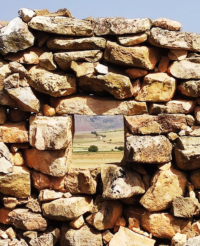 Meseta framed through a dry-stone wall near Atienza